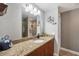 Bright bathroom showcasing a granite countertop, a decorative mirror, and modern fixtures at 194 Sportsman Rd, Rotonda West, FL 33947