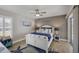 Cozy guest bedroom featuring coastal decor, a ceiling fan, and ample natural light from window and glass door at 194 Sportsman Rd, Rotonda West, FL 33947