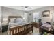 Comfortable bedroom showcasing a ceiling fan, natural light, and a work space area at 194 Sportsman Rd, Rotonda West, FL 33947