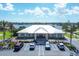 A community building with ample parking and palm trees set against a tranquil lakeside backdrop at 194 Sportsman Rd, Rotonda West, FL 33947