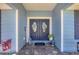 Welcoming front entrance with double doors, decorative wreaths, and a charming welcome mat at 194 Sportsman Rd, Rotonda West, FL 33947