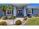 Charming home featuring a colorful front entrance and well-manicured landscaping at 194 Sportsman Rd, Rotonda West, FL 33947