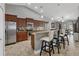 Kitchen boasts stainless steel appliances, wood cabinets, and a breakfast bar with seating at 194 Sportsman Rd, Rotonda West, FL 33947