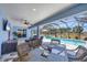 Enclosed lanai featuring outdoor dining with a view of a pool, spa, and expansive backyard at 194 Sportsman Rd, Rotonda West, FL 33947