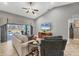 Cozy living room featuring vaulted ceilings and sliding glass doors to the pool at 194 Sportsman Rd, Rotonda West, FL 33947