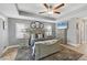 Spacious main bedroom with a tray ceiling, neutral decor, and plantation shutters at 194 Sportsman Rd, Rotonda West, FL 33947