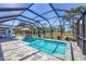 Enclosed pool and spa area surrounded by a spacious deck and lush greenery, creating a serene backyard retreat at 194 Sportsman Rd, Rotonda West, FL 33947