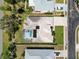 Bird's eye view of home showing backyard screened pool, lush lawn, and tile roof at 201 Bayside Ct, Nokomis, FL 34275