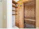 Bathroom with sauna featuring wooden walls and benches, complemented by a shower with white tiles and wooden shelves at 201 Bayside Ct, Nokomis, FL 34275