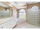 Bright bathroom features a soaking tub, walk-in shower, and double sink vanity at 201 Bayside Ct, Nokomis, FL 34275