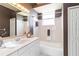 Cozy bathroom featuring a single sink vanity, a bathtub/shower combo and a large mirror at 201 Bayside Ct, Nokomis, FL 34275