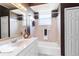 Cozy bathroom featuring a single sink vanity, a bathtub/shower combo and a large mirror at 201 Bayside Ct, Nokomis, FL 34275