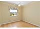 Bedroom featuring hardwood floors, neutral walls, and a ceiling fan at 201 Bayside Ct, Nokomis, FL 34275