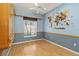 Bedroom with hardwood floors, two-tone paint, and built in shelving unit at 201 Bayside Ct, Nokomis, FL 34275