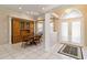Cozy dining area with built-in cabinet, round table, arched windows, and decorative entry doors at 201 Bayside Ct, Nokomis, FL 34275