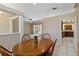 Elegant dining room featuring a wood table with seating for four, and open view to the living area at 201 Bayside Ct, Nokomis, FL 34275