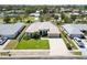 Beautiful single-story home featuring a lush green lawn, arched entry, and a two-car garage at 201 Bayside Ct, Nokomis, FL 34275