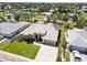 Expansive view of a home with a well-manicured lawn and tiled roof in a residential neighborhood at 201 Bayside Ct, Nokomis, FL 34275