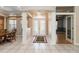 Welcoming foyer with tiled floors, decorative entry door, and elegant archway to adjoining living spaces at 201 Bayside Ct, Nokomis, FL 34275