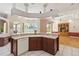 Well-appointed kitchen with a center island, ample counter space, and a view of the backyard through a large window at 201 Bayside Ct, Nokomis, FL 34275