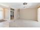Spacious living room with plush carpet, ceiling fan, and open entryway to other living spaces at 201 Bayside Ct, Nokomis, FL 34275