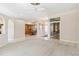 Open living room with carpet floors, ceiling fan, views to dining room, and entryway to front door at 201 Bayside Ct, Nokomis, FL 34275