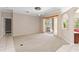 Bright living room with plush carpet, ceiling fan, access to the patio, and view of the outdoors at 201 Bayside Ct, Nokomis, FL 34275