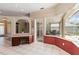 Cozy office area features dark wood cabinets and desktop, tile flooring and a view into an enclosed outdoor living area at 201 Bayside Ct, Nokomis, FL 34275