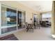 Covered patio with comfortable seating, ceiling fan, and sliding glass doors with a view of the pool area at 201 Bayside Ct, Nokomis, FL 34275