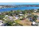 Beautiful aerial view of waterfront homes, lush landscaping, and stunning blue water in the background at 203 Palm Ave, Nokomis, FL 34275