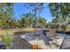 Backyard area featuring a brick patio with Adirondack chairs surrounding a fire pit at 203 Palm Ave, Nokomis, FL 34275
