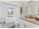 Bathroom featuring a shower with tub, mermaid artwork, and a sink with modern fixtures at 203 Palm Ave, Nokomis, FL 34275