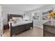 Bedroom with a decorative wood bed frame and light-filled window at 203 Palm Ave, Nokomis, FL 34275