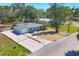 Exterior view of the home features a well-maintained lawn, mature trees, and a convenient driveway for easy parking at 203 Palm Ave, Nokomis, FL 34275