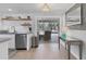 Bright kitchen with stainless steel dishwasher, adjacent to the lanai at 203 Palm Ave, Nokomis, FL 34275