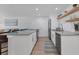 Bright kitchen with white cabinets, gray countertops, and stainless-steel appliances at 203 Palm Ave, Nokomis, FL 34275