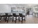 Bright kitchen with modern appliances, island, breakfast bar, and open access to the lanai at 203 Palm Ave, Nokomis, FL 34275