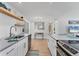 Open kitchen featuring white cabinets, stainless steel appliances, and a view to the living room at 203 Palm Ave, Nokomis, FL 34275
