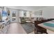 The living room features a large comfortable sofa, lots of light from the windows, and modern decor at 203 Palm Ave, Nokomis, FL 34275