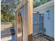 Outdoor shower featuring wooden and metal elements, with surfboard art detail at 203 Palm Ave, Nokomis, FL 34275