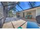 Covered patio featuring stylish furniture, surfboards, and view of a spacious backyard at 203 Palm Ave, Nokomis, FL 34275