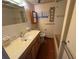 Bathroom with wood vanity, toilet, shower-tub, framed mirror, and light-colored walls and tile at 218 Outer Dr, Venice, FL 34285