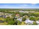 An aerial view captures a home with a screened enclosure in a green, residential neighborhood at 2187 Calusa Lakes Blvd, Nokomis, FL 34275