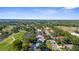 Aerial view of homes in a lush community next to a lake and golf course under a sunny sky at 2187 Calusa Lakes Blvd, Nokomis, FL 34275