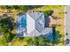 Aerial view of property with screened in pool, patio, well manicured lawn, and distinct roof design at 2187 Calusa Lakes Blvd, Nokomis, FL 34275