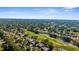An aerial view of a neighborhood with golf course, ponds, lush trees, and beautiful homes at 2187 Calusa Lakes Blvd, Nokomis, FL 34275