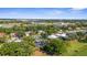 An aerial view of a home featuring a screened-in pool in a lush, green neighborhood setting at 2187 Calusa Lakes Blvd, Nokomis, FL 34275