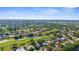 Beautiful aerial view of the community showcasing the mature landscaping, ponds and golf course at 2187 Calusa Lakes Blvd, Nokomis, FL 34275
