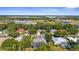An aerial shot showcases a home with a screened lanai in a neighborhood surrounded by trees at 2187 Calusa Lakes Blvd, Nokomis, FL 34275