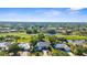 An aerial view captures stunning homes near a golf course, pond, and lush greenery in a neighborhood at 2187 Calusa Lakes Blvd, Nokomis, FL 34275
